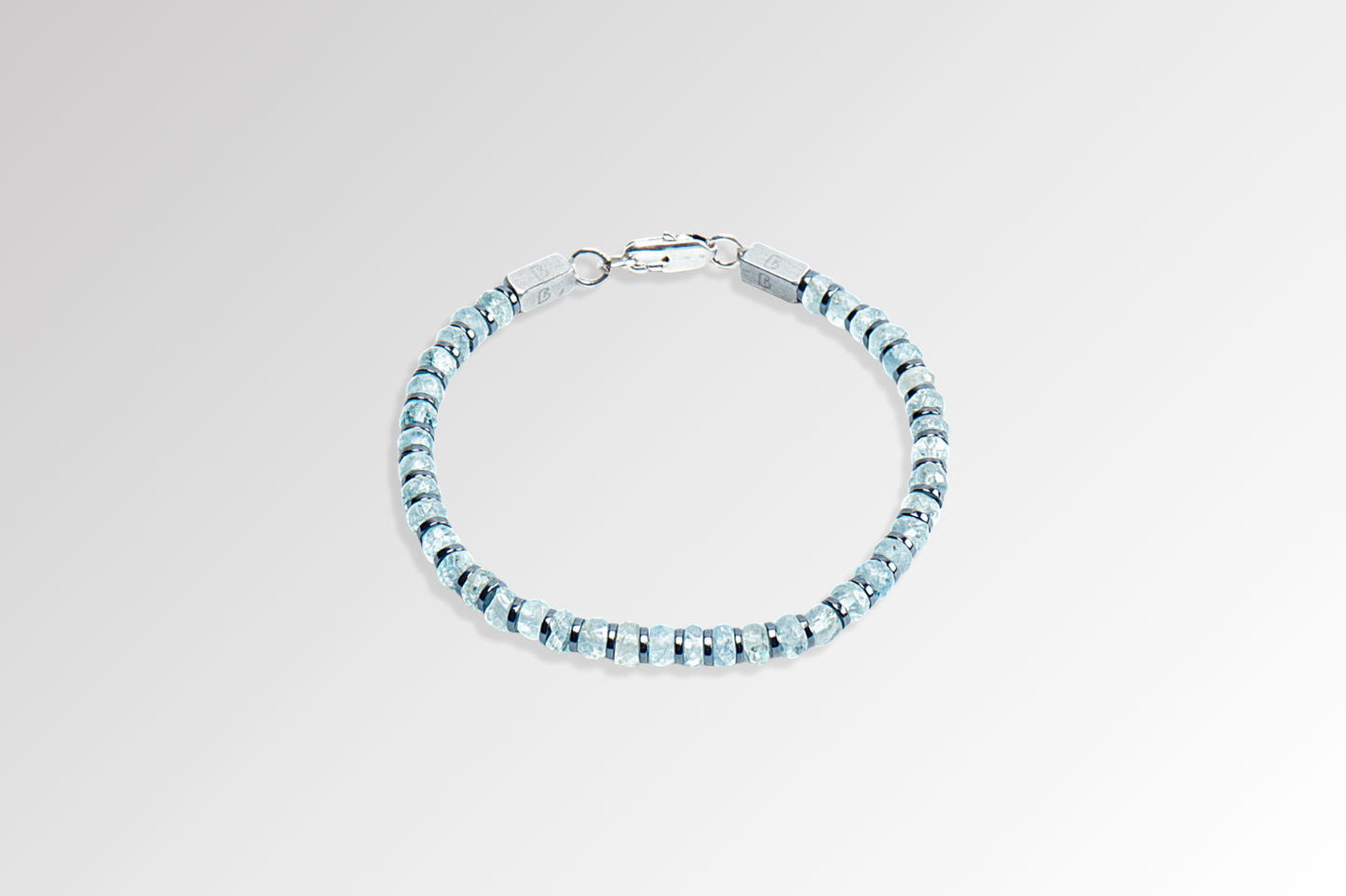Beneka Aquamarine Bracelet – Natural Stone Clasp-Lock Bracelet featuring faceted disc-cut Aquamarine beads (2–3mm) with elegant gunmetal-finish spacers and clasp, handcrafted on premium elastic silicone cord. Luxury gemstone jewelry for calmness, clarity, and ocean-inspired style.