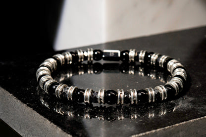 Black Onyx Bracelet by Beneka – Natural Stone Slip-On Bracelet with 6mm polished Black Onyx beads, stainless steel rings, and premium elastic silicone cord. Elegant unisex luxury wrist accessory for protection, style, and energy balance.